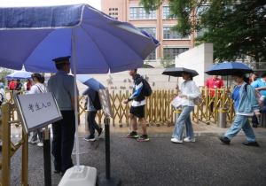高考首日北京交警雨中值守，加强考点周边秩序疏导