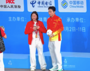 男子3米板决赛颁奖仪式结束后 王宗源将金牌递给全红婵一起拍照