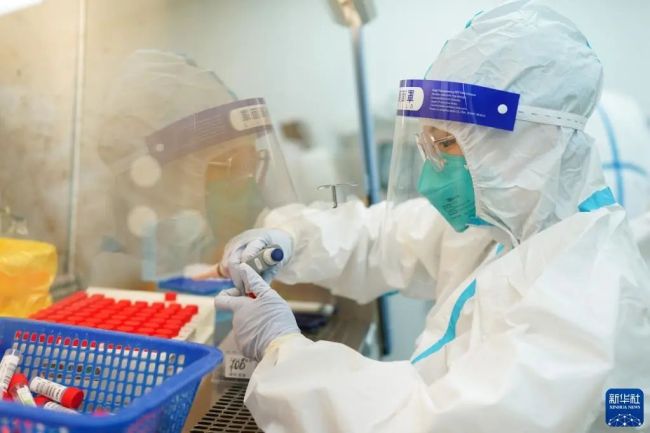 3月23日凌晨,同济大学附属同济医院内的核酸检测实验室灯火通明,工作人员紧张而有序地进行核酸检测工作。新华社记者 丁汀 摄