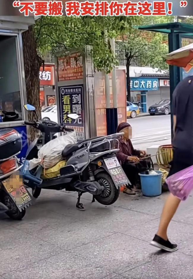 老人路边摆摊遭同行驱赶 女城管霸气回护：不要搬，我安排你在这里